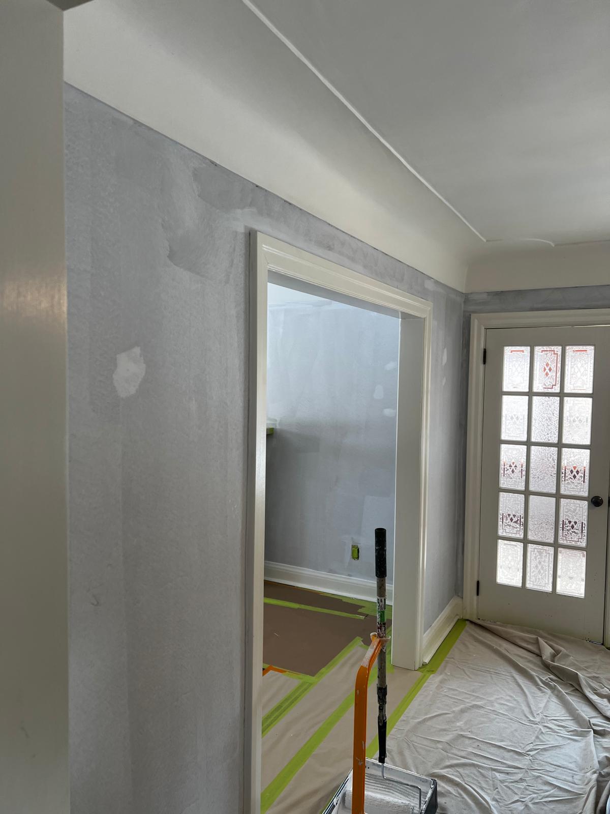 Doorway and walls with primer coat and floor protection