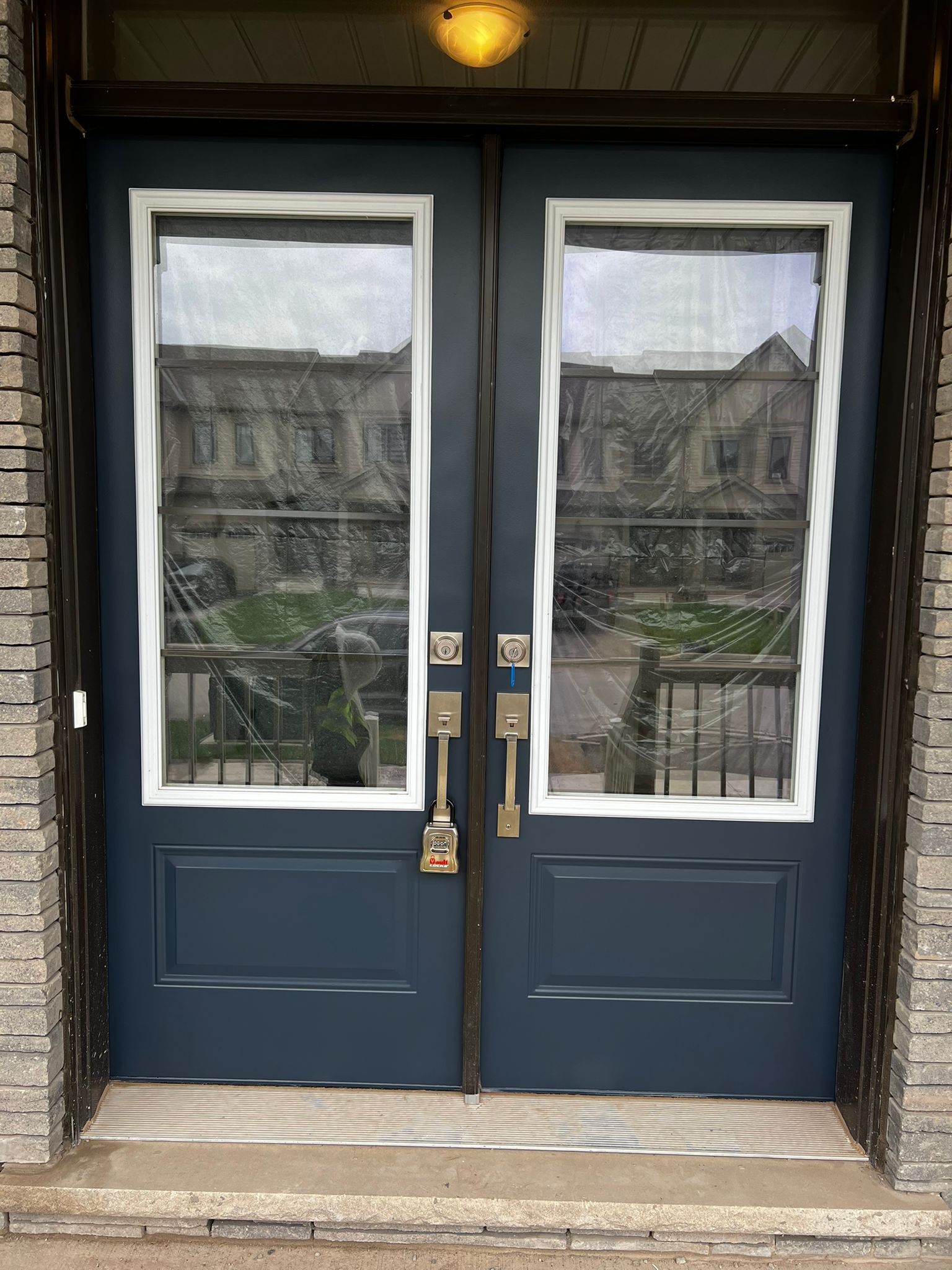 Navy blue painted double front doors with white trim