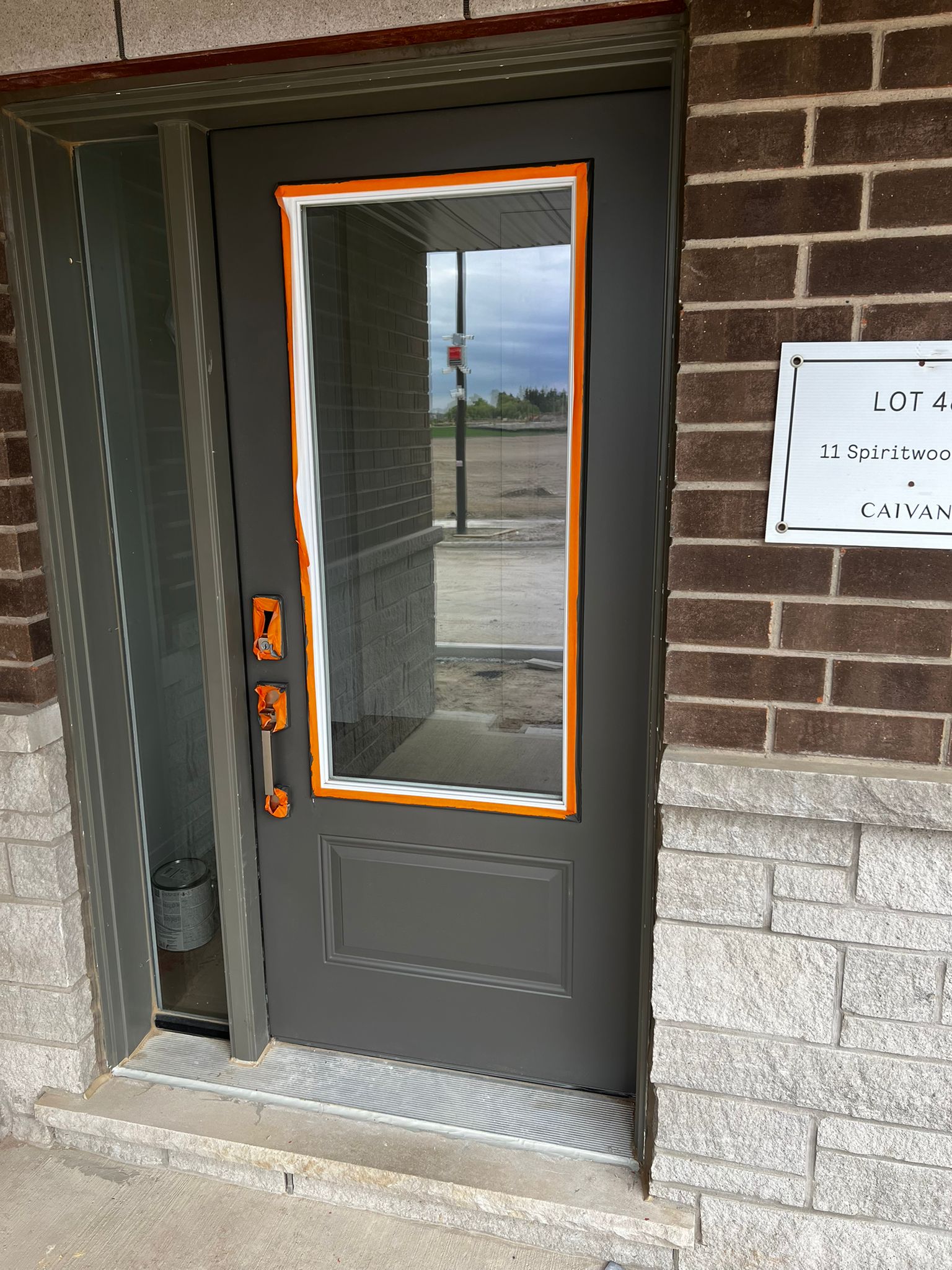Front door masked with orange tape for painting preparation