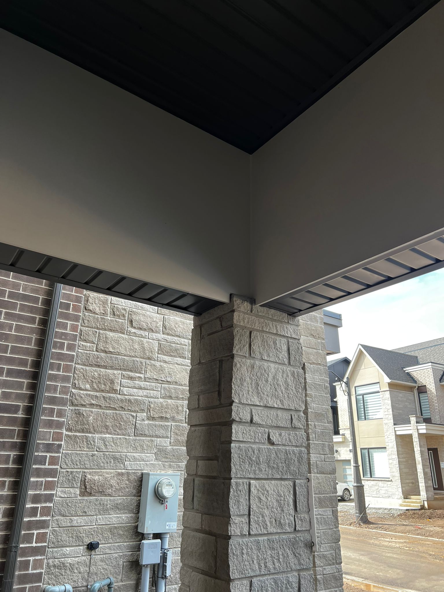 Painted soffit and stone column on residential porch
