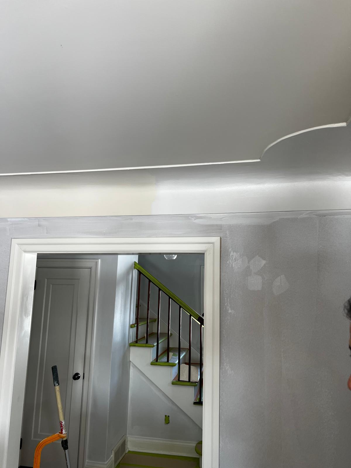 Staircase area with primer coat and protective tape on railings